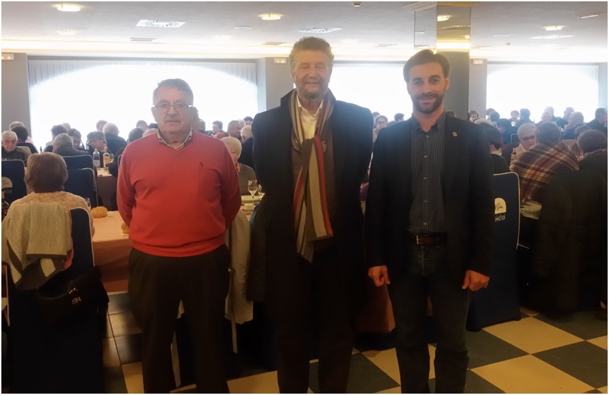 Julin Huerta (presidente de los Jubilados) con los alcaldes de Navia y de Cabranes; y los comensales al fondo./ Foto: Emma Moatassim
