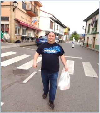 Fernando, camino de su taxi el pasado mircoles, con una bolsa para atender un servicios solicitado./ EL ECO